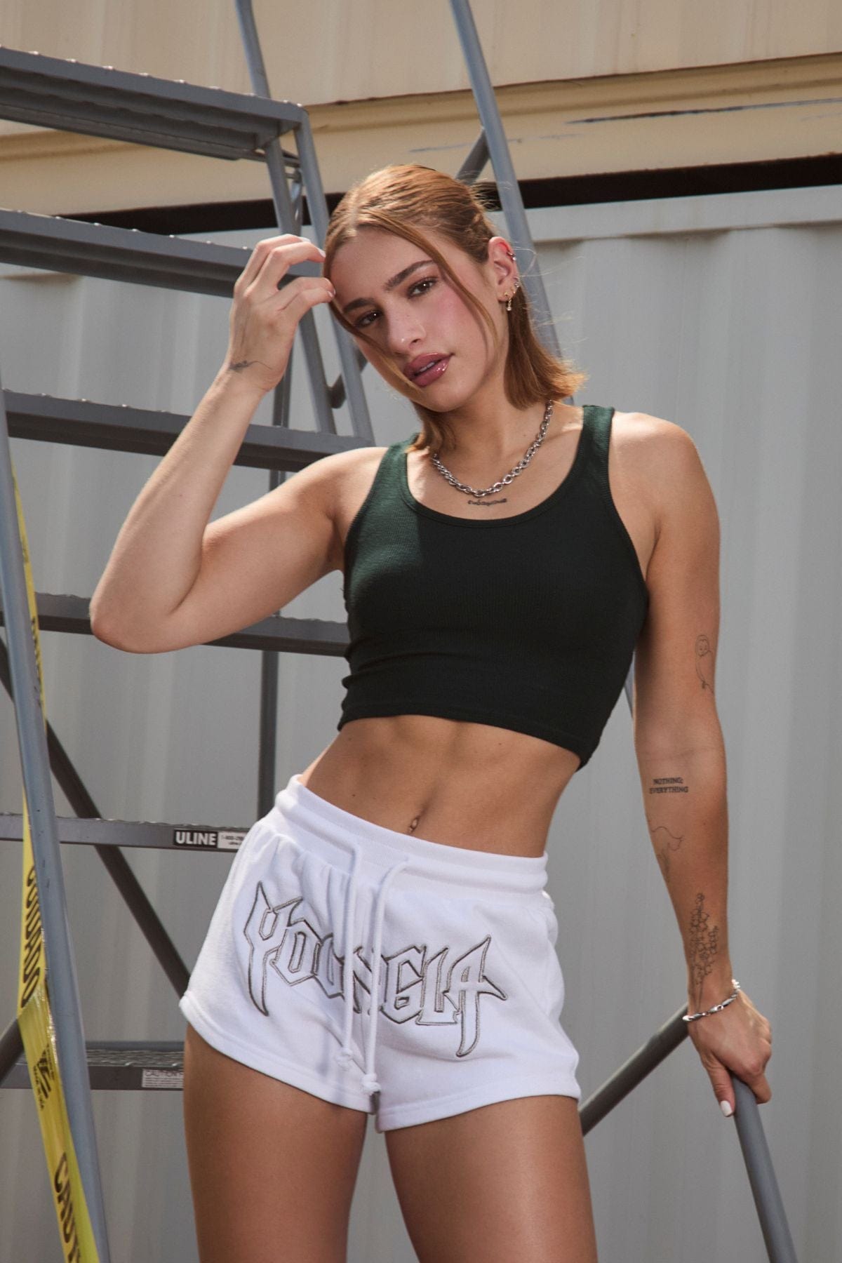 Model wearing the tank with womens activewear accessories, shot outdoors in sunny California