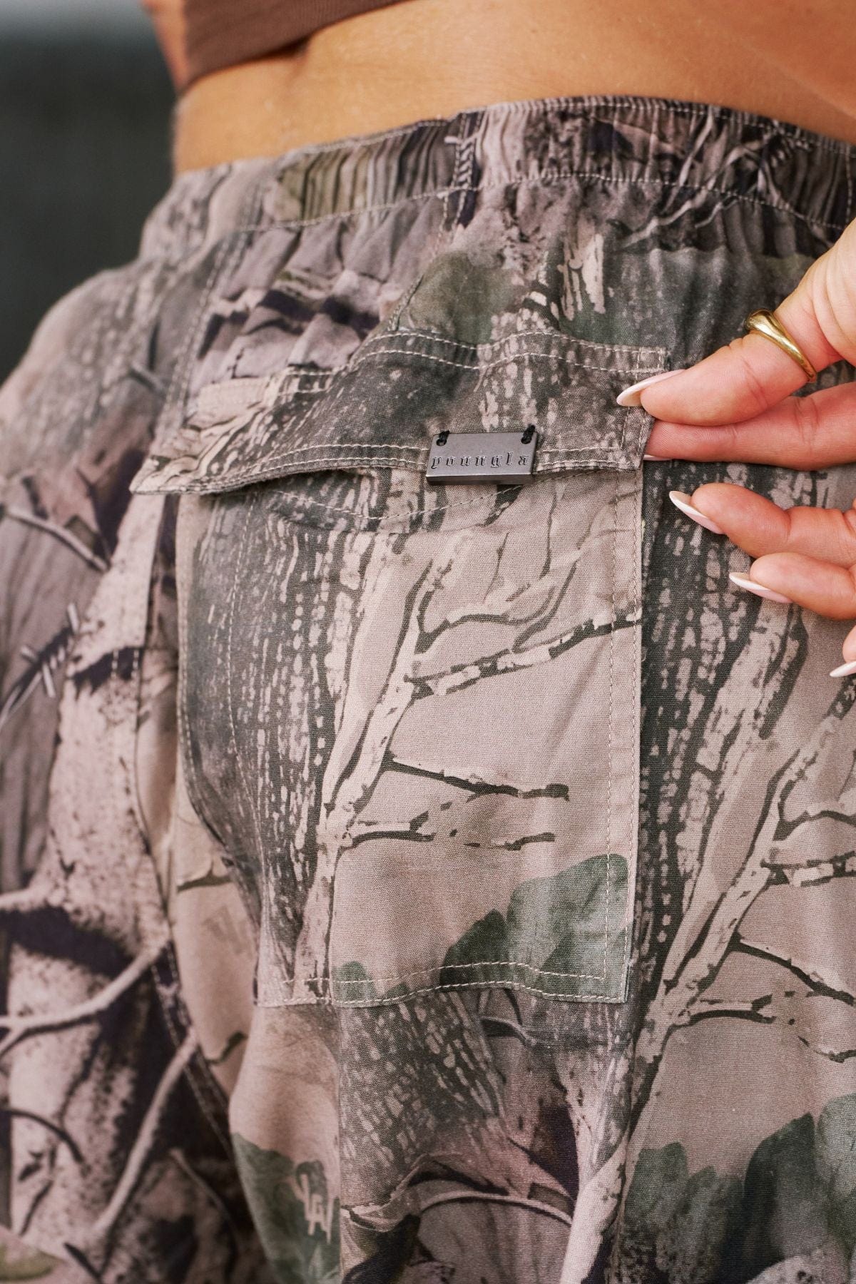 Front view of baggy cargo pants with drawstring waist and cuffed ankles