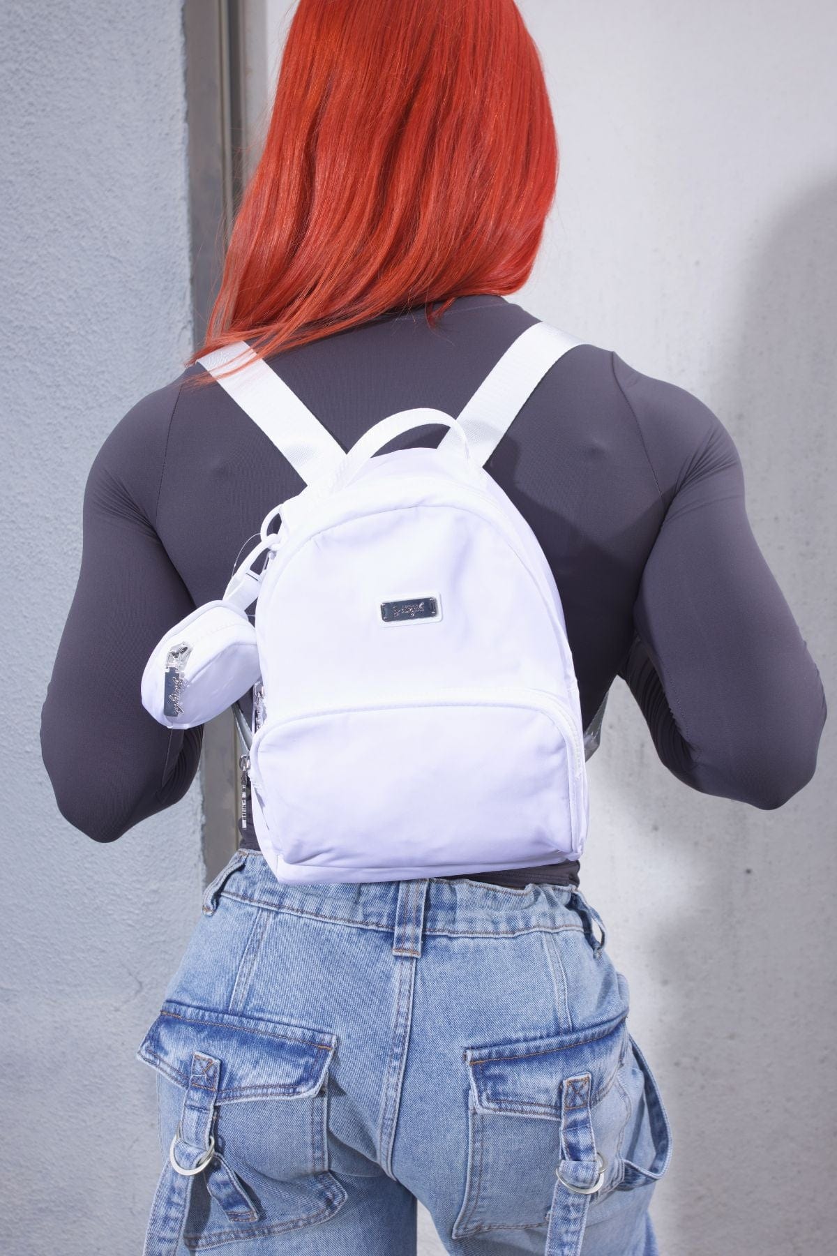 Lightweight backpack hanging on a park bench showing size and build