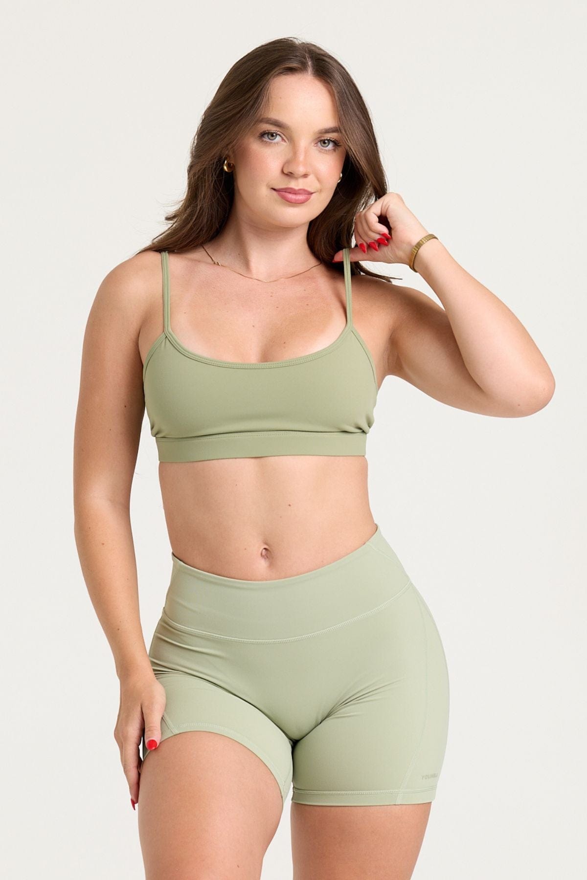 Woman stretching in the gym wearing the supportive workout bra for high-impact activities