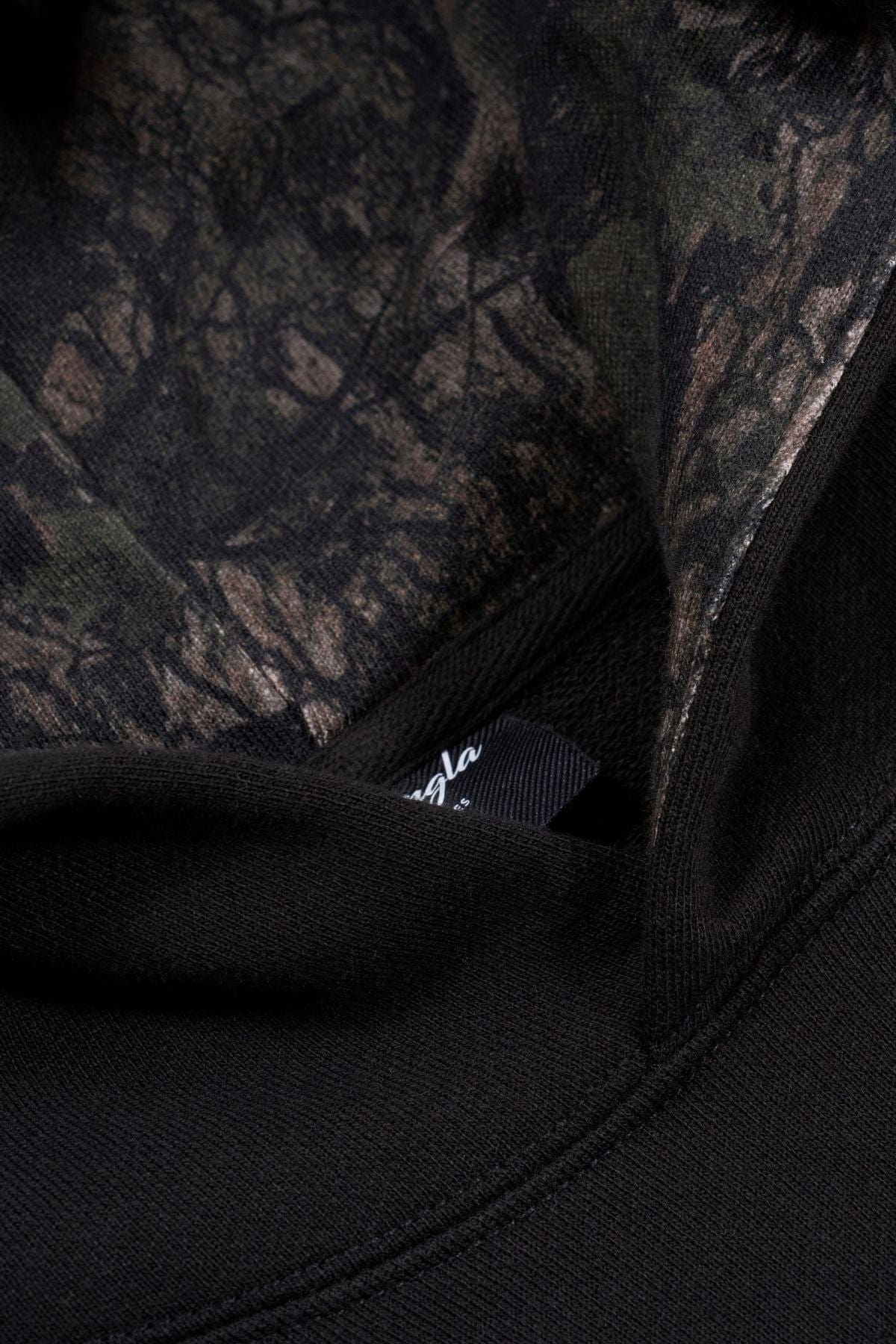 Front view of the oversized hunting hoodie in a natural setting.