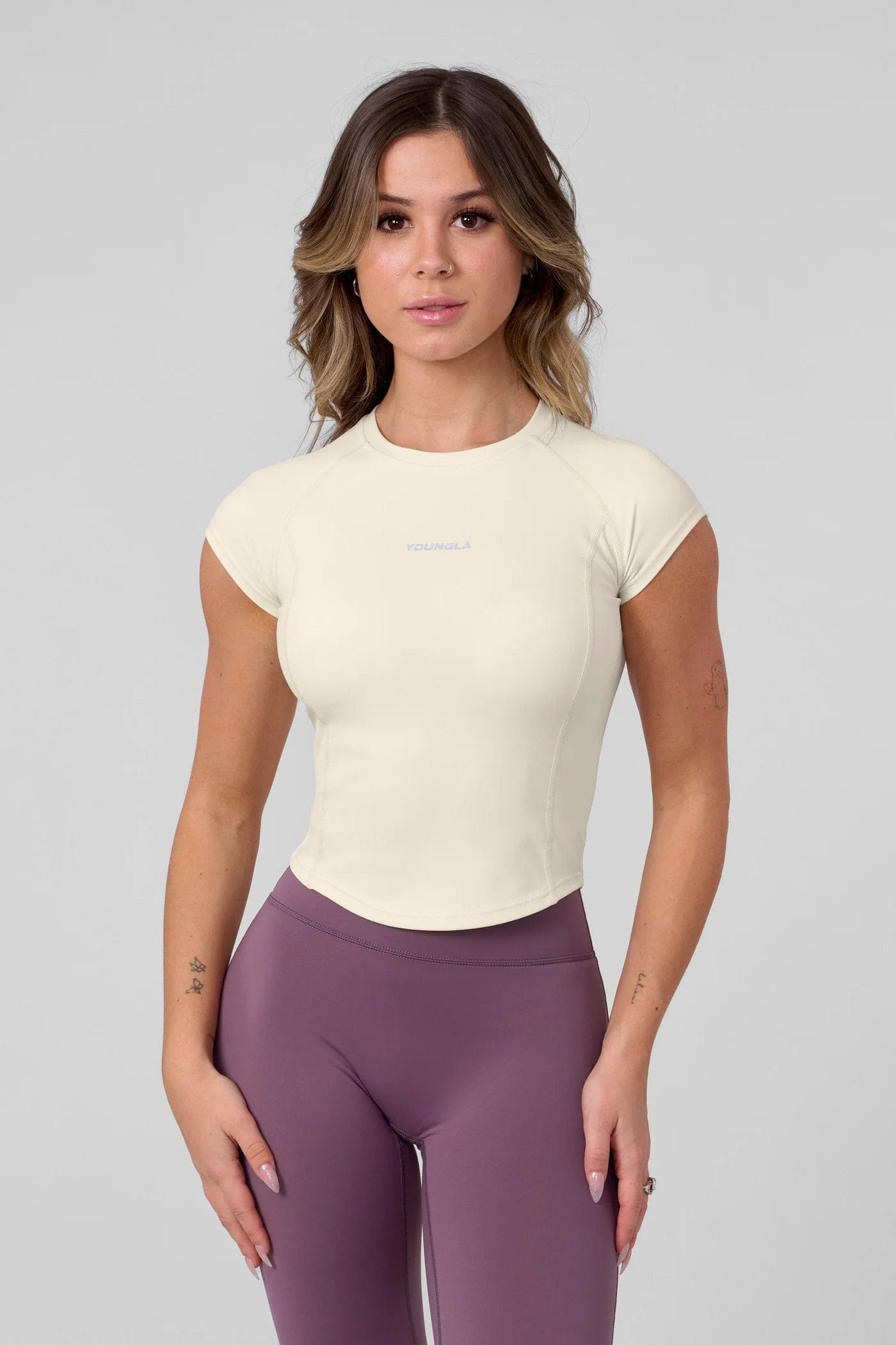 Front view of a woman wearing a womens compression shirt during exercise