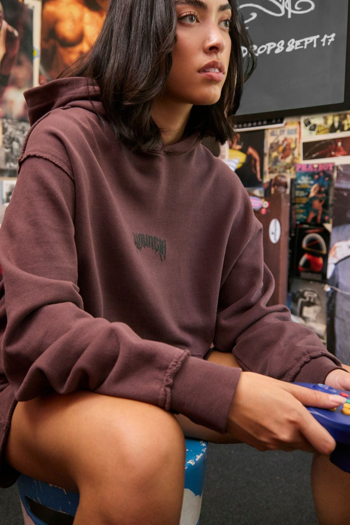 Streetwear outfit pairing the hoodie with black jeans and sneakers