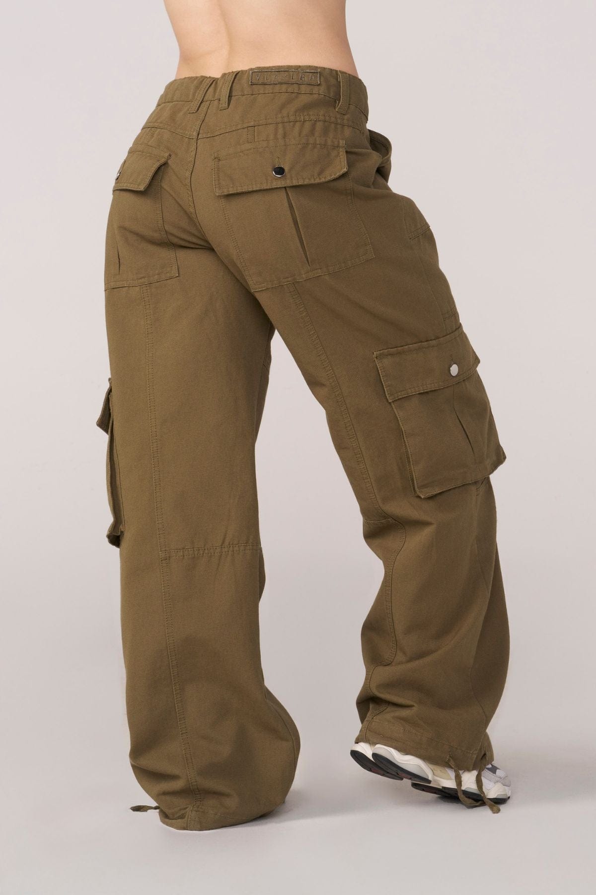 Close-up of waistband adjusters on black cargo pants for streetwear outfits