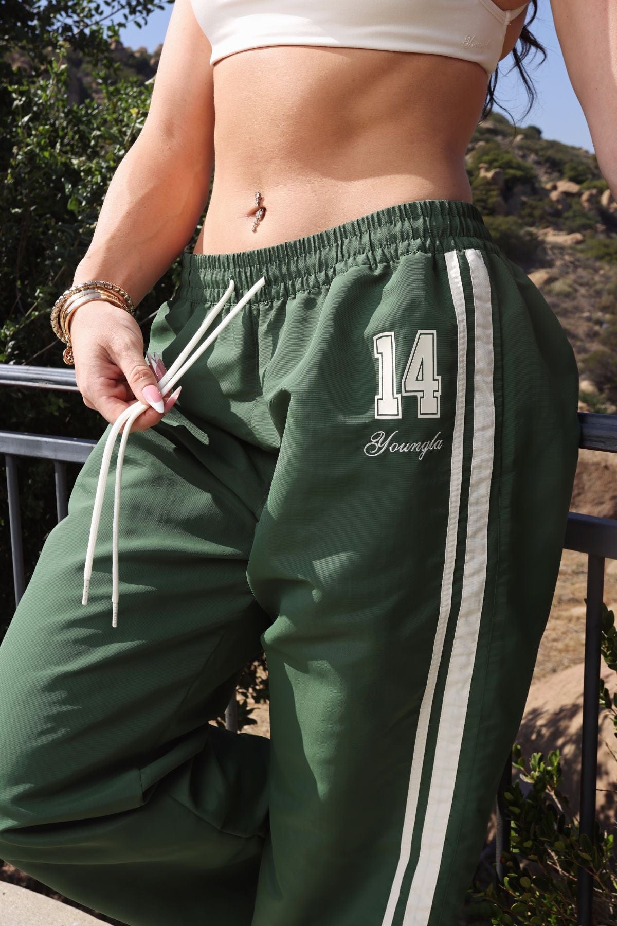 Side view showcasing adjustable ankles of athletic pants.