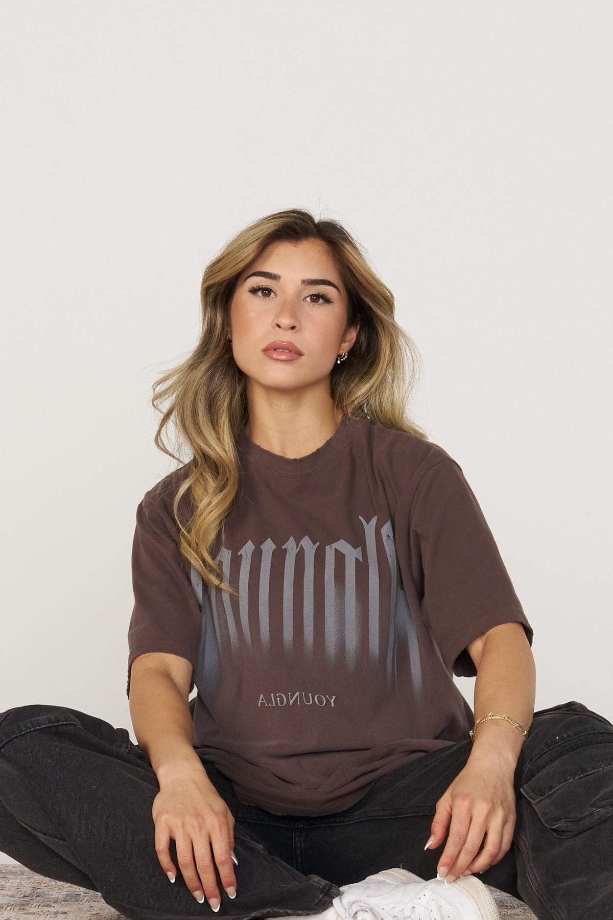 Model wearing the oversized T shirt with smoke print, paired with jeans for a relaxed look