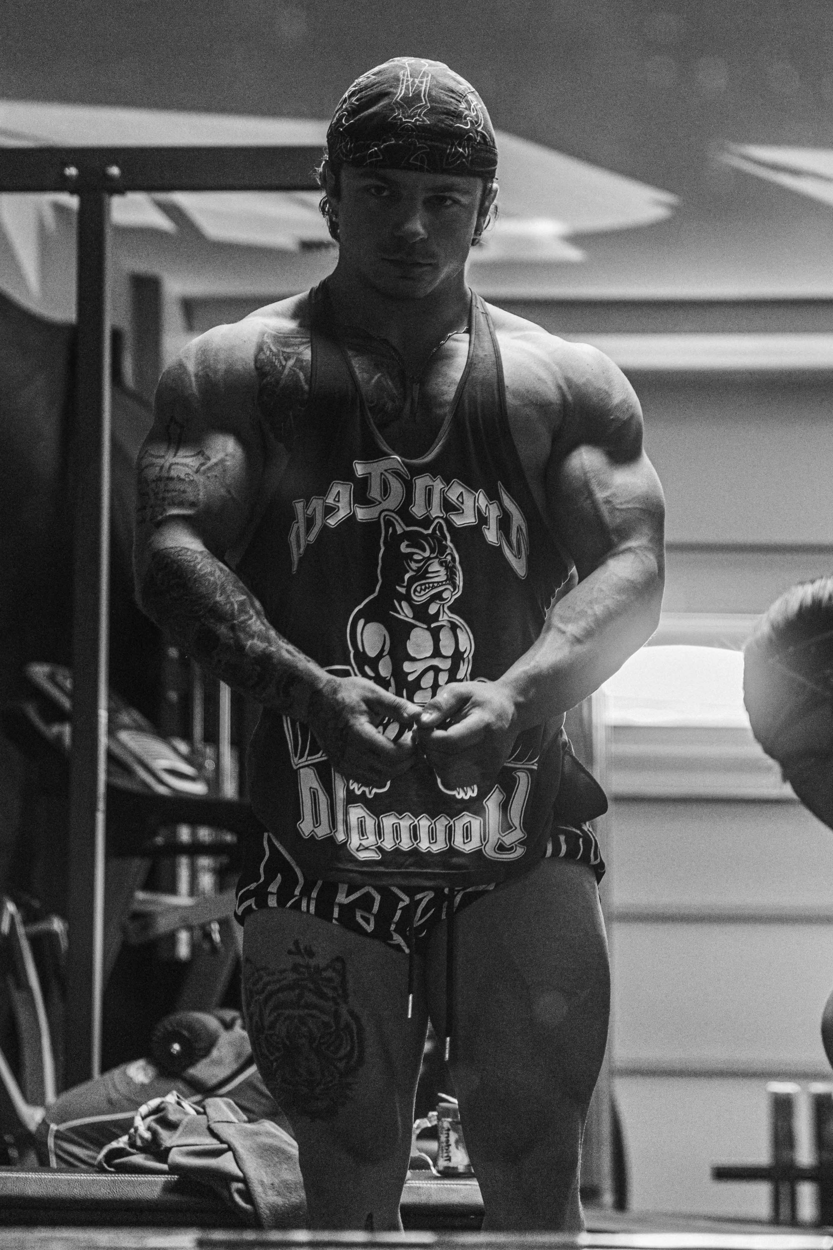 Tren Twins stringer tank top showcasing muscle definition