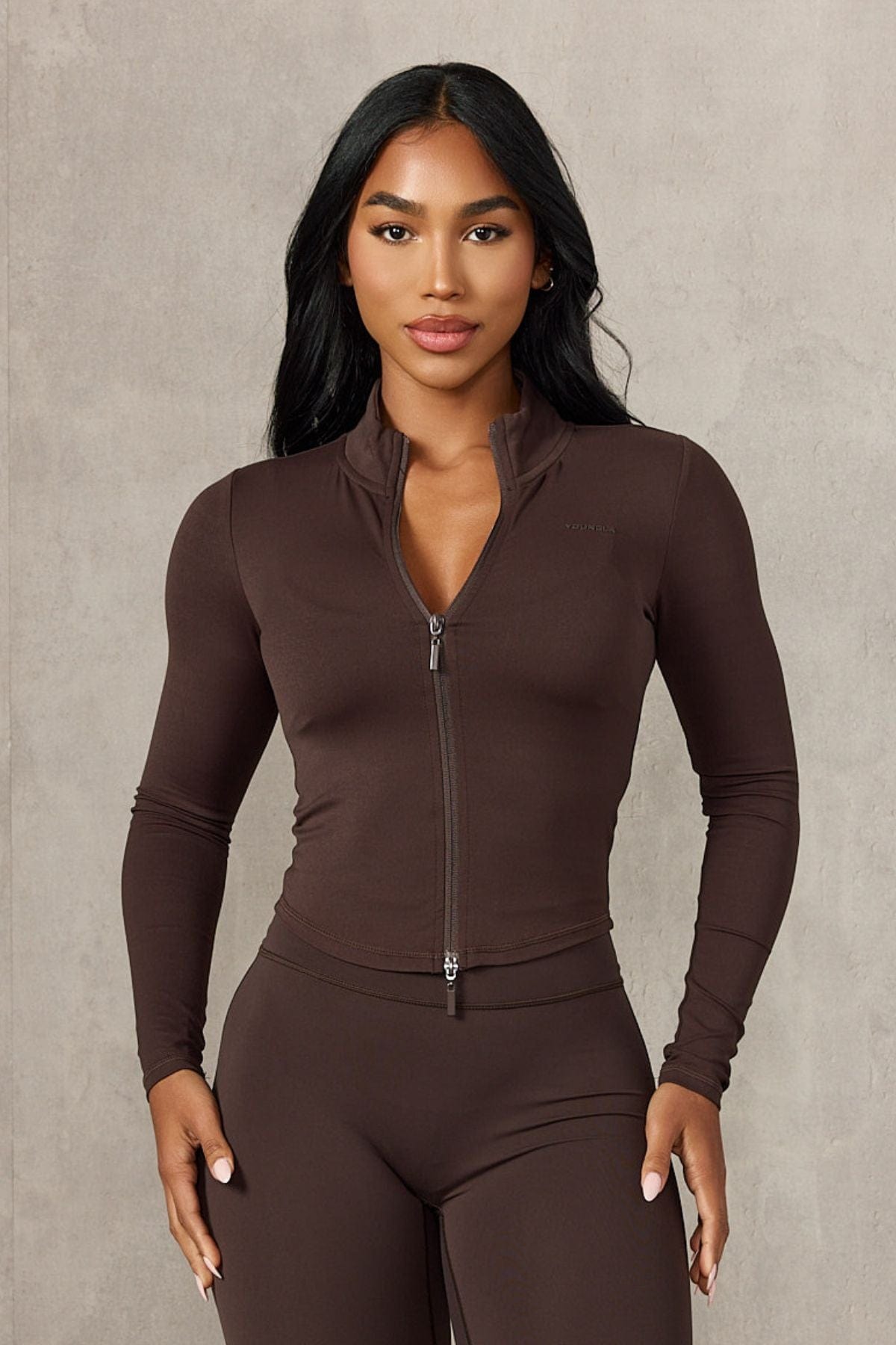 Back view of the fitted jacket styled with activewear dresses