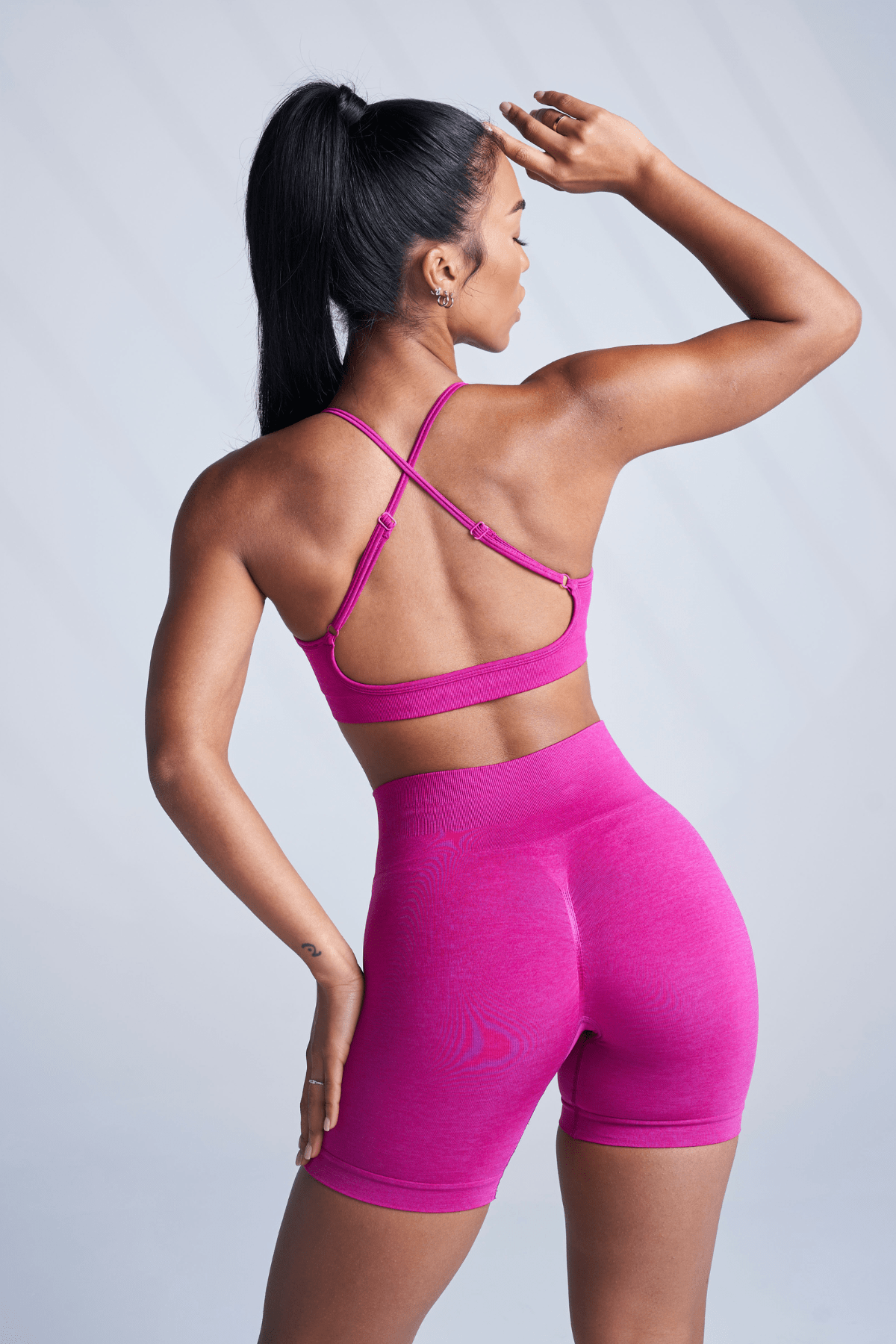 Model wearing seamless bra from back angle during yoga session