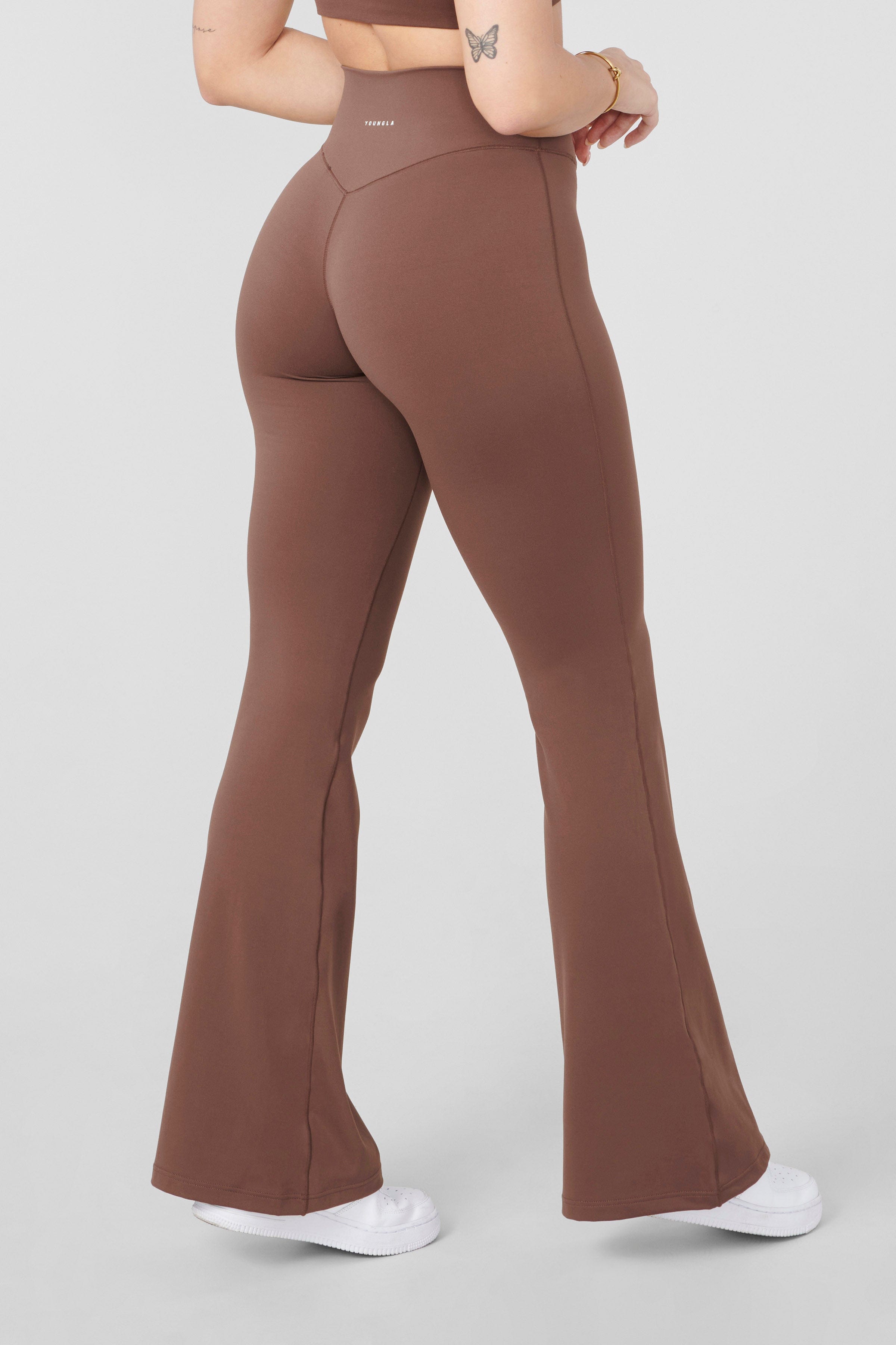 Back view of the model in Vital Flare Leggings, demonstrating the flattering fit.