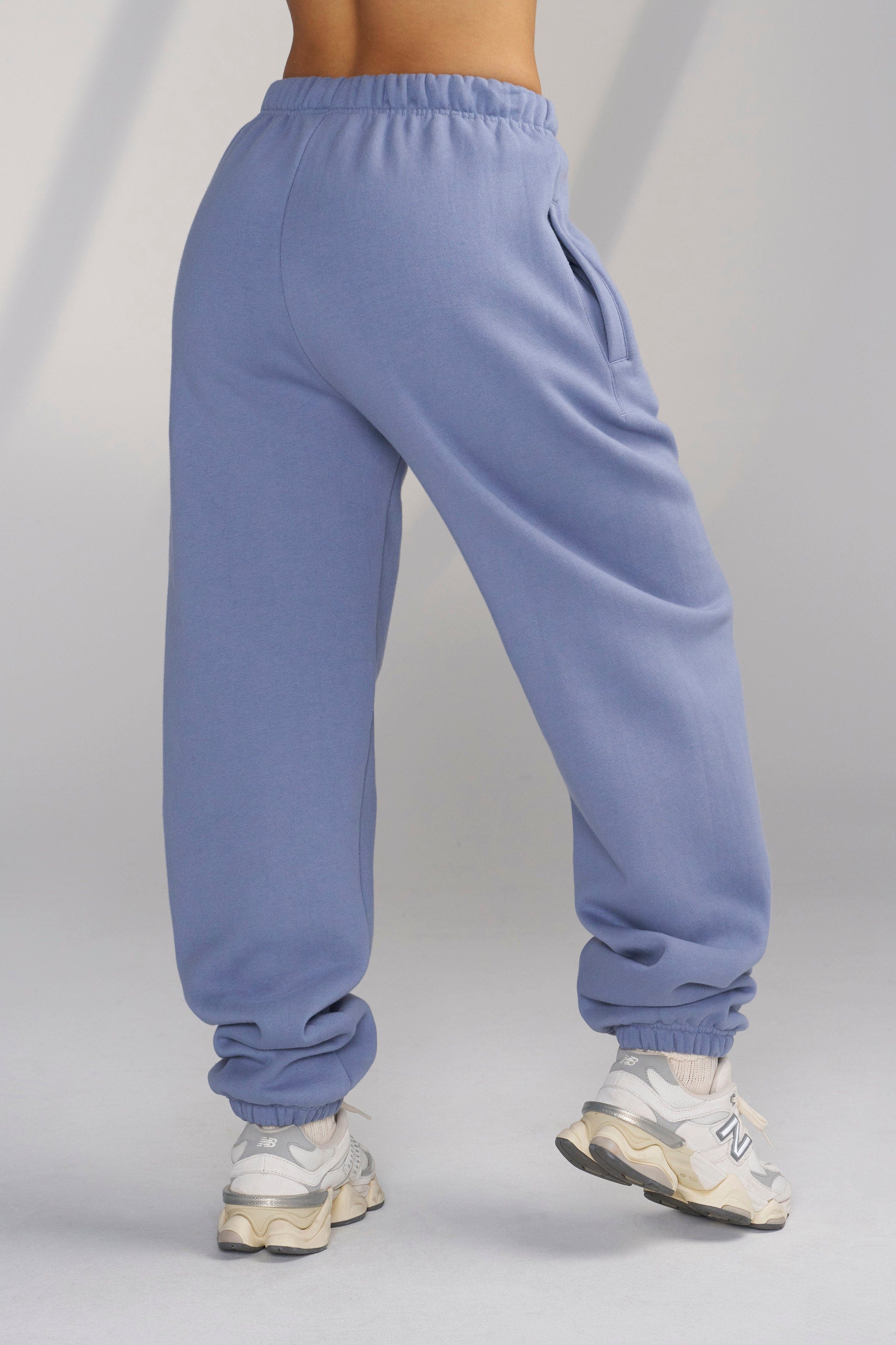 Side view of Teddy fleece joggers highlighting comfortable fit and embroidered logo