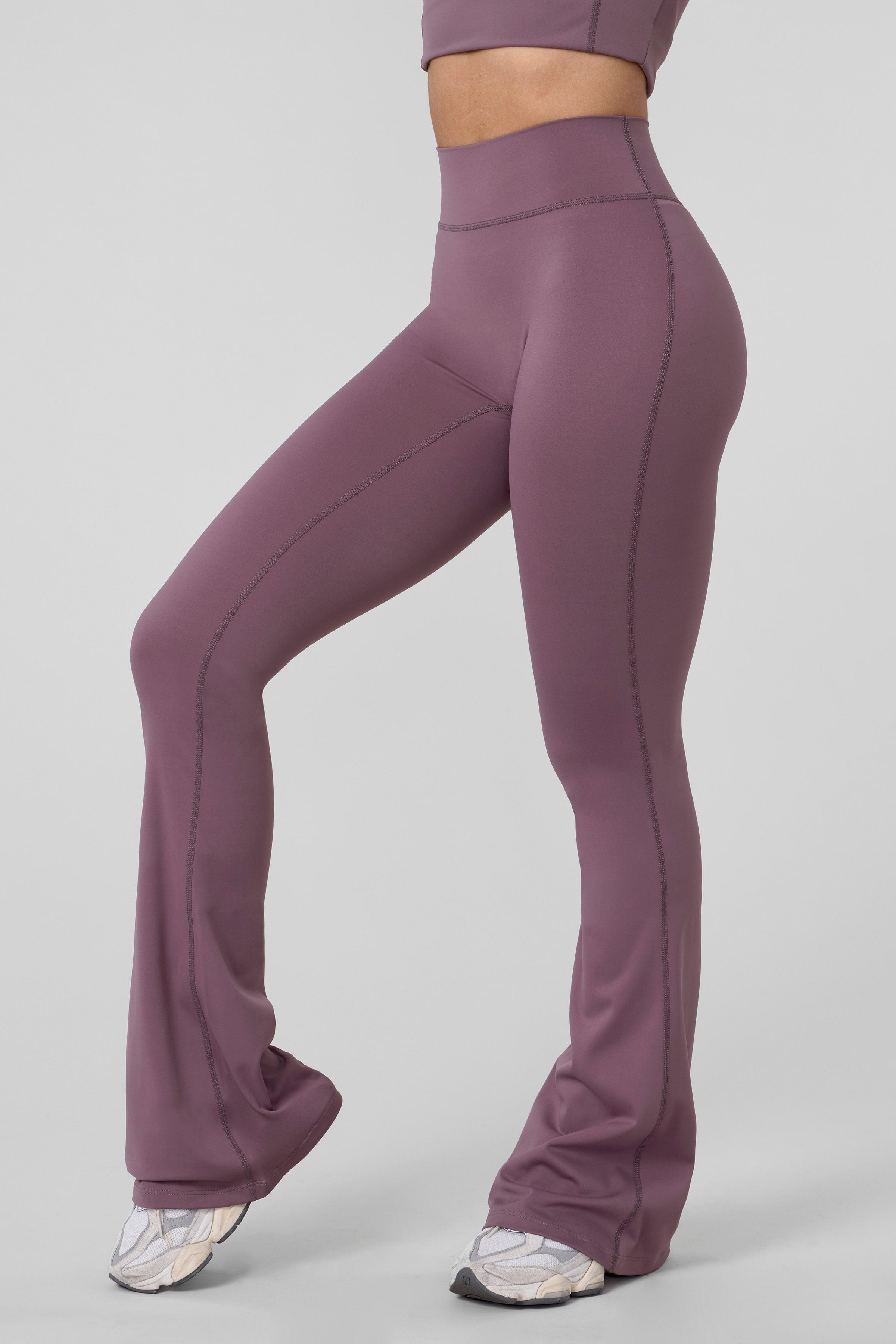 Close-up of high-waist grey flare leggings on a model