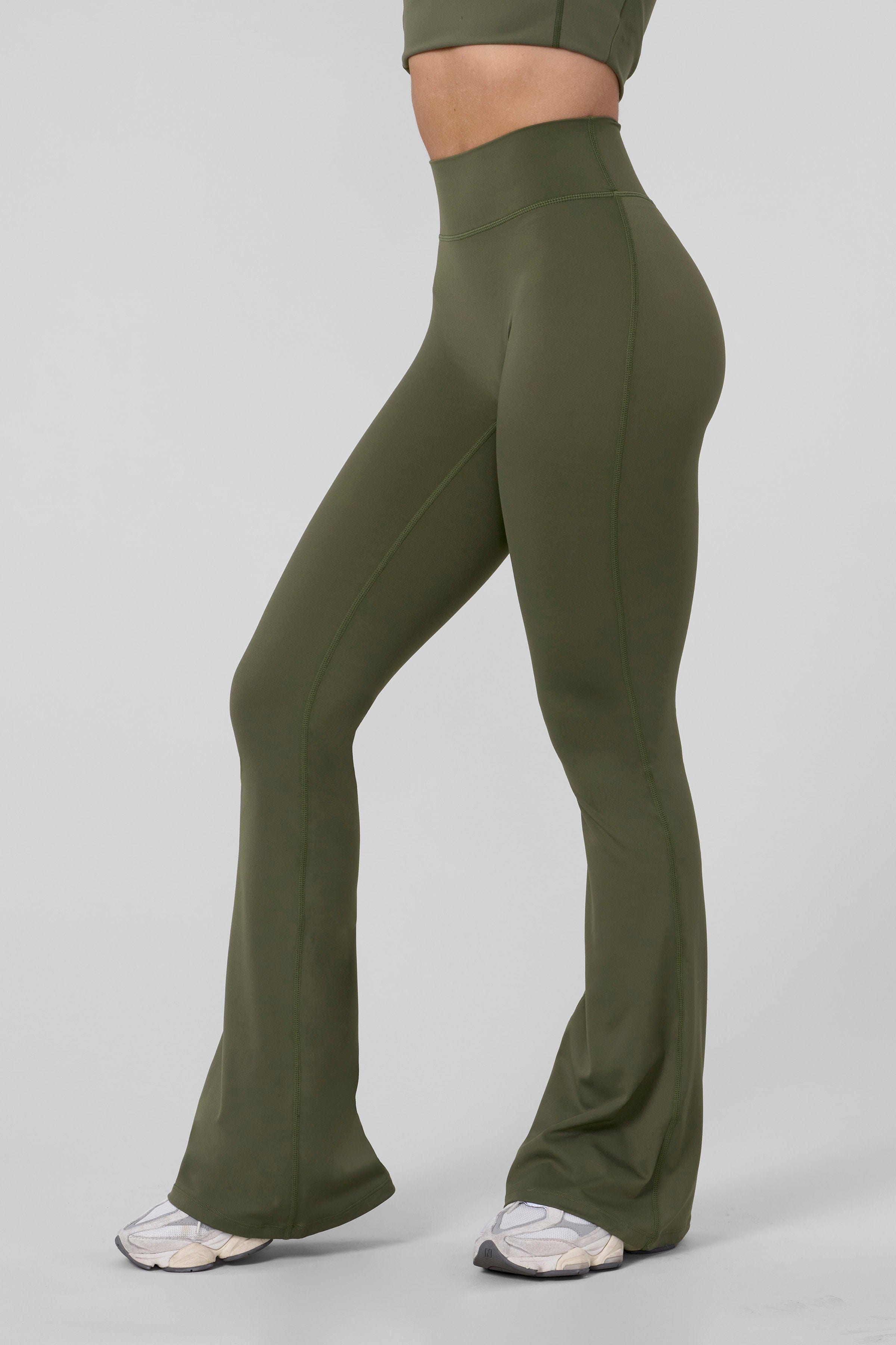 Close-up of high-waist grey flare leggings on a model