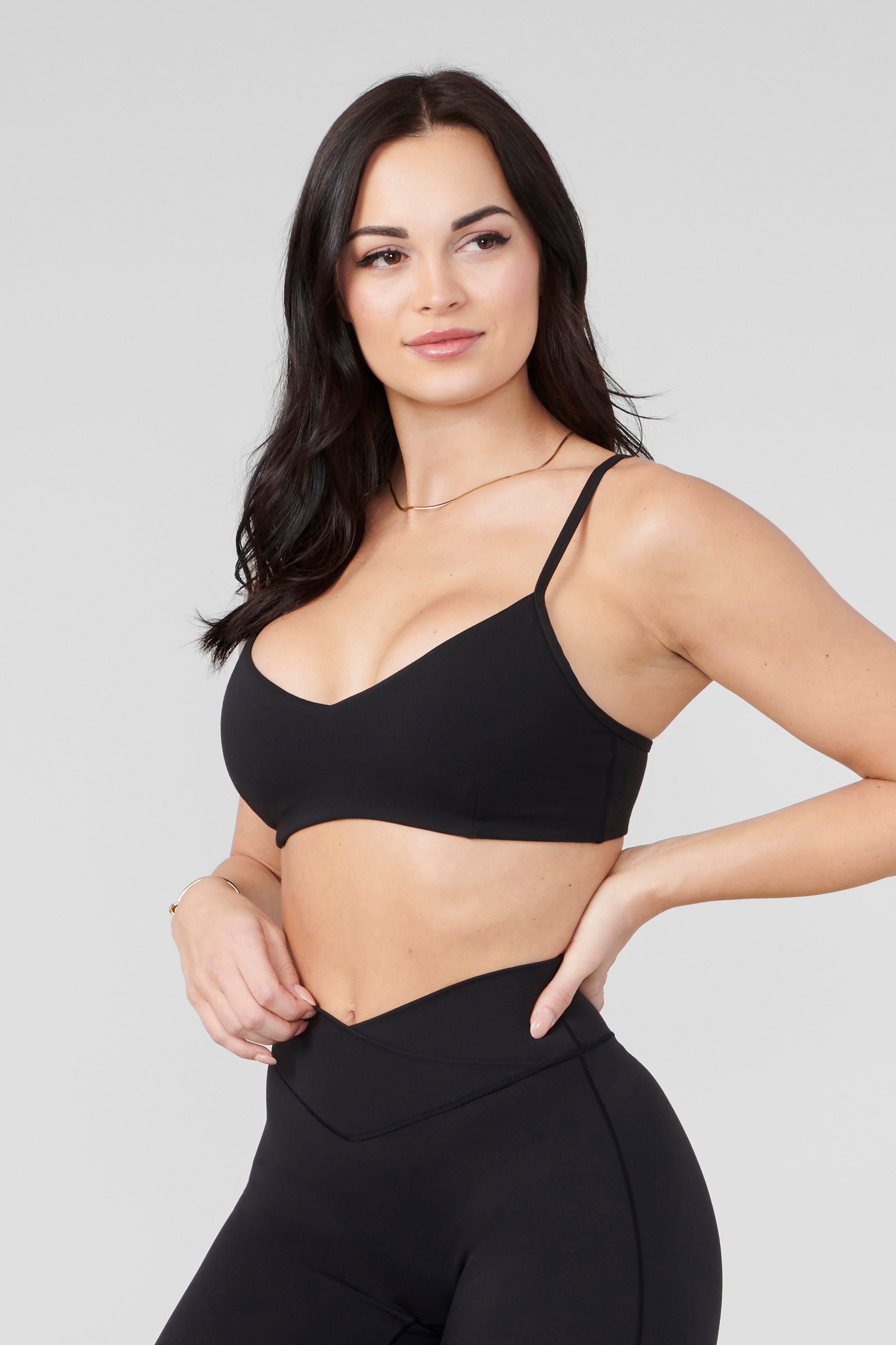 Side view of a model in the Vital Performance Sports Bra paired with Vital Flare leggings.