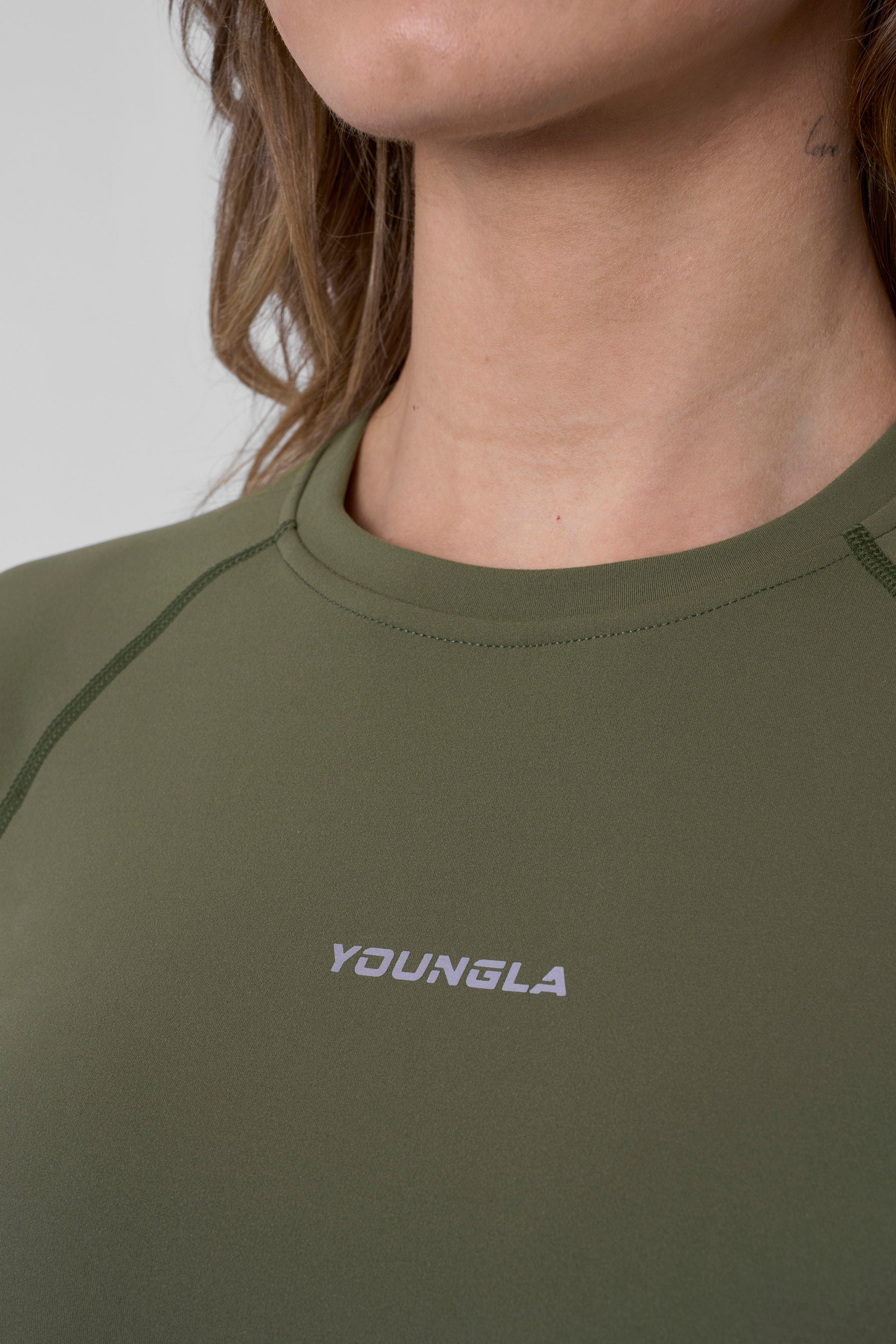 Active woman stretching outdoors in her womens compression shirt
