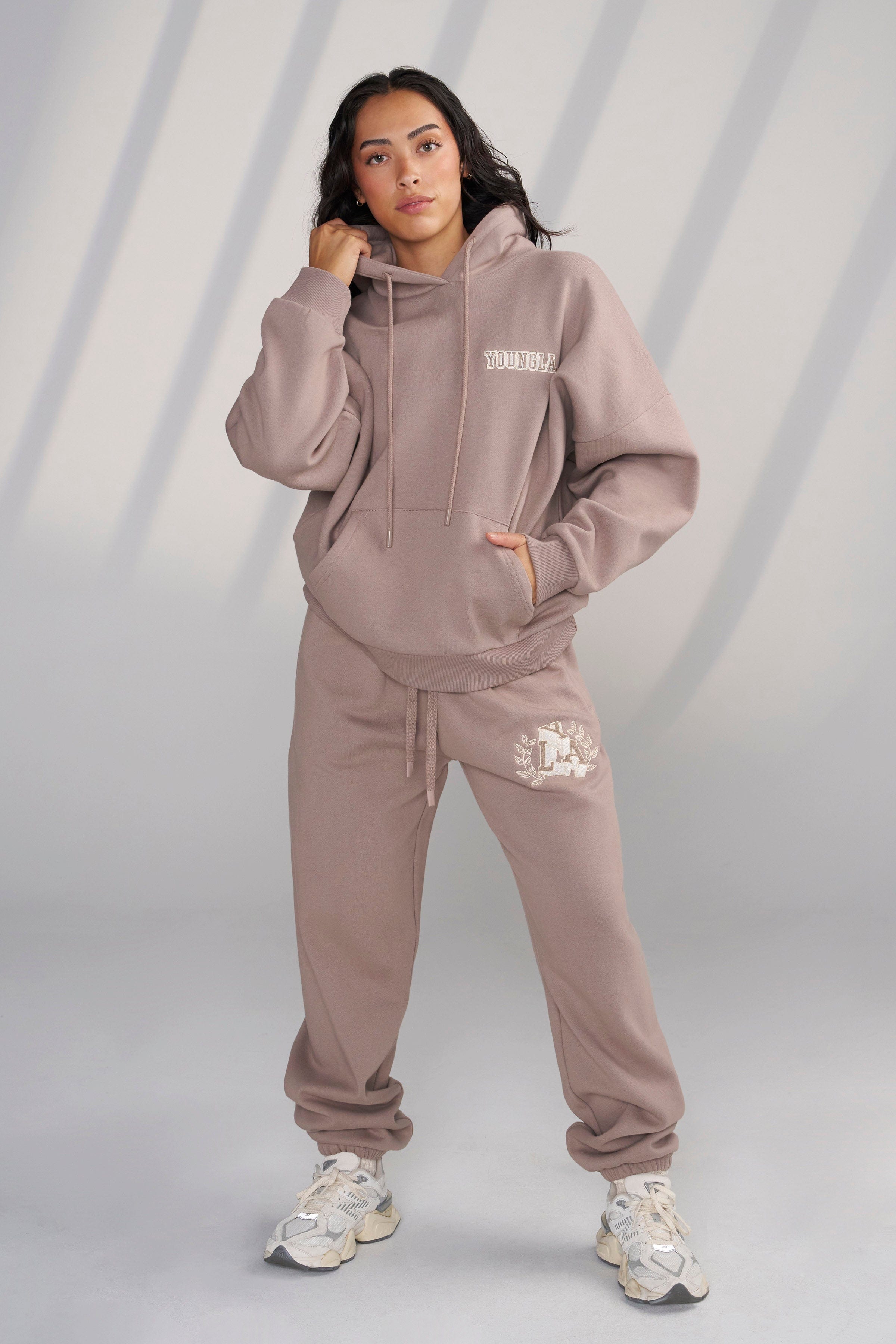 Side view showing the plush chenille patch detail on the hoodie.