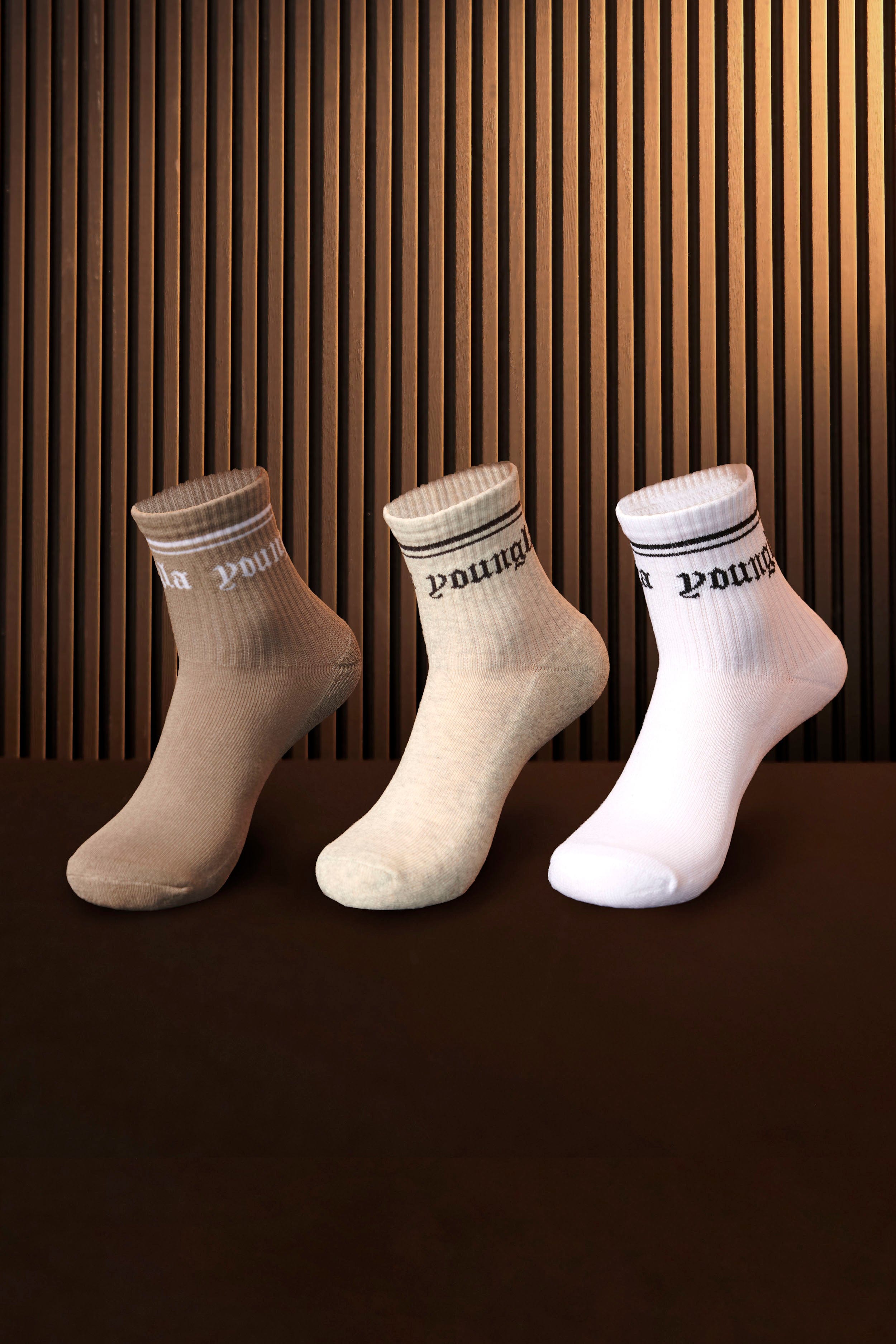Three pairs of crew socks folded together, showcasing the neutral color palette