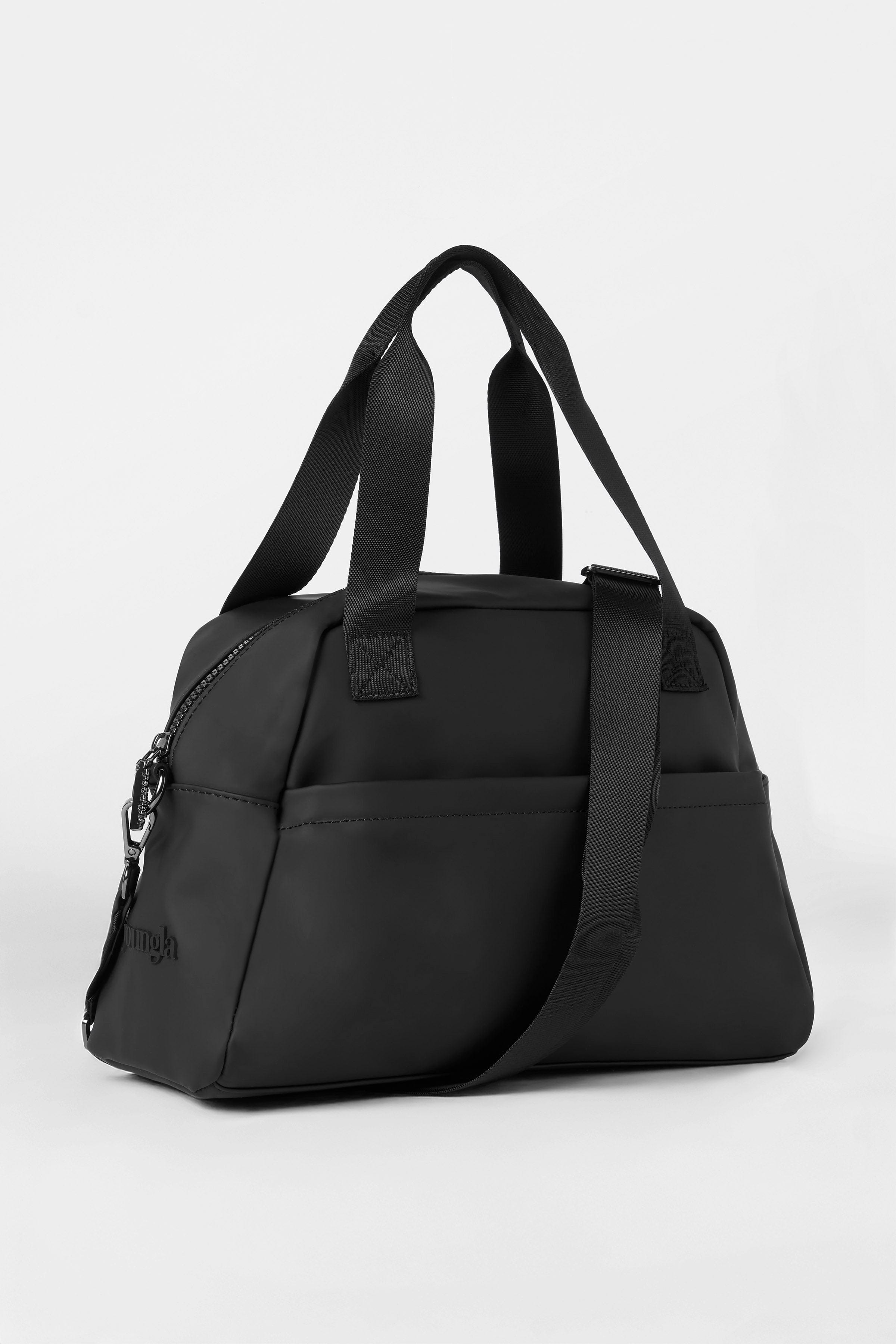 Lifestyle shot of the mini duffle bag purse being used at the gym.