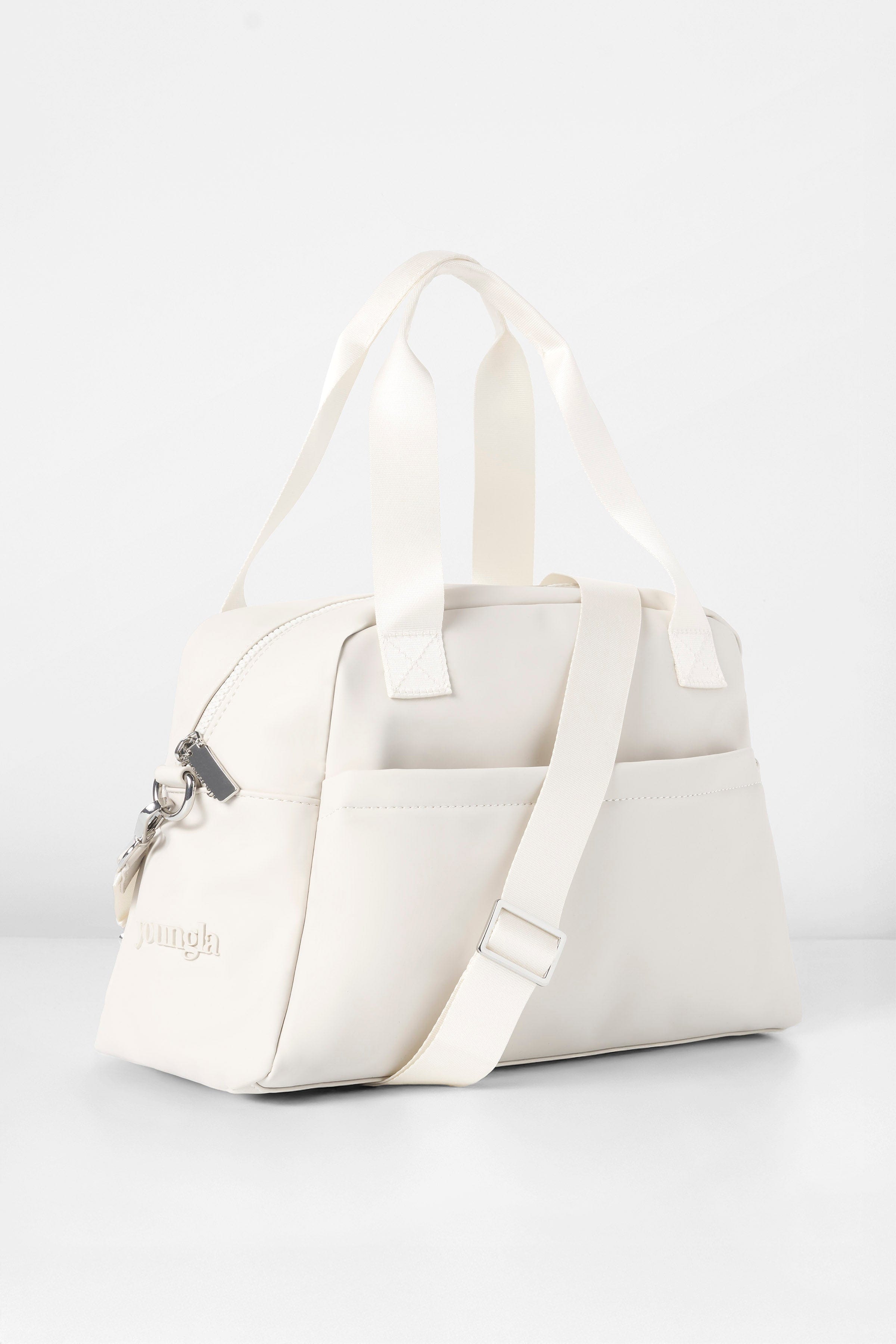 Front view of the sleek mini duffle bag showcasing its pockets.