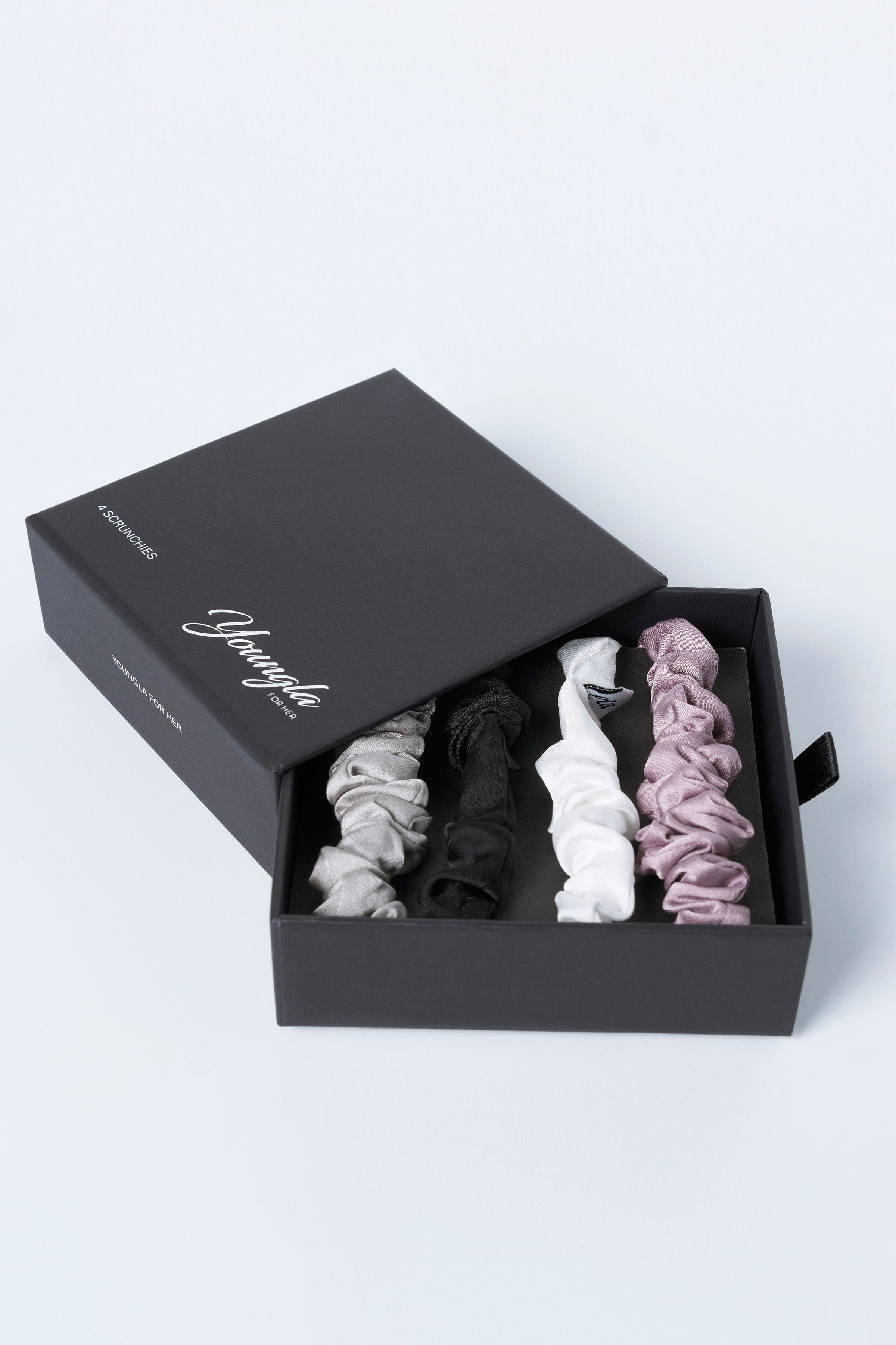 Satin scrunchies worn on a wrist, highlighting their versatility as stylish accessories.