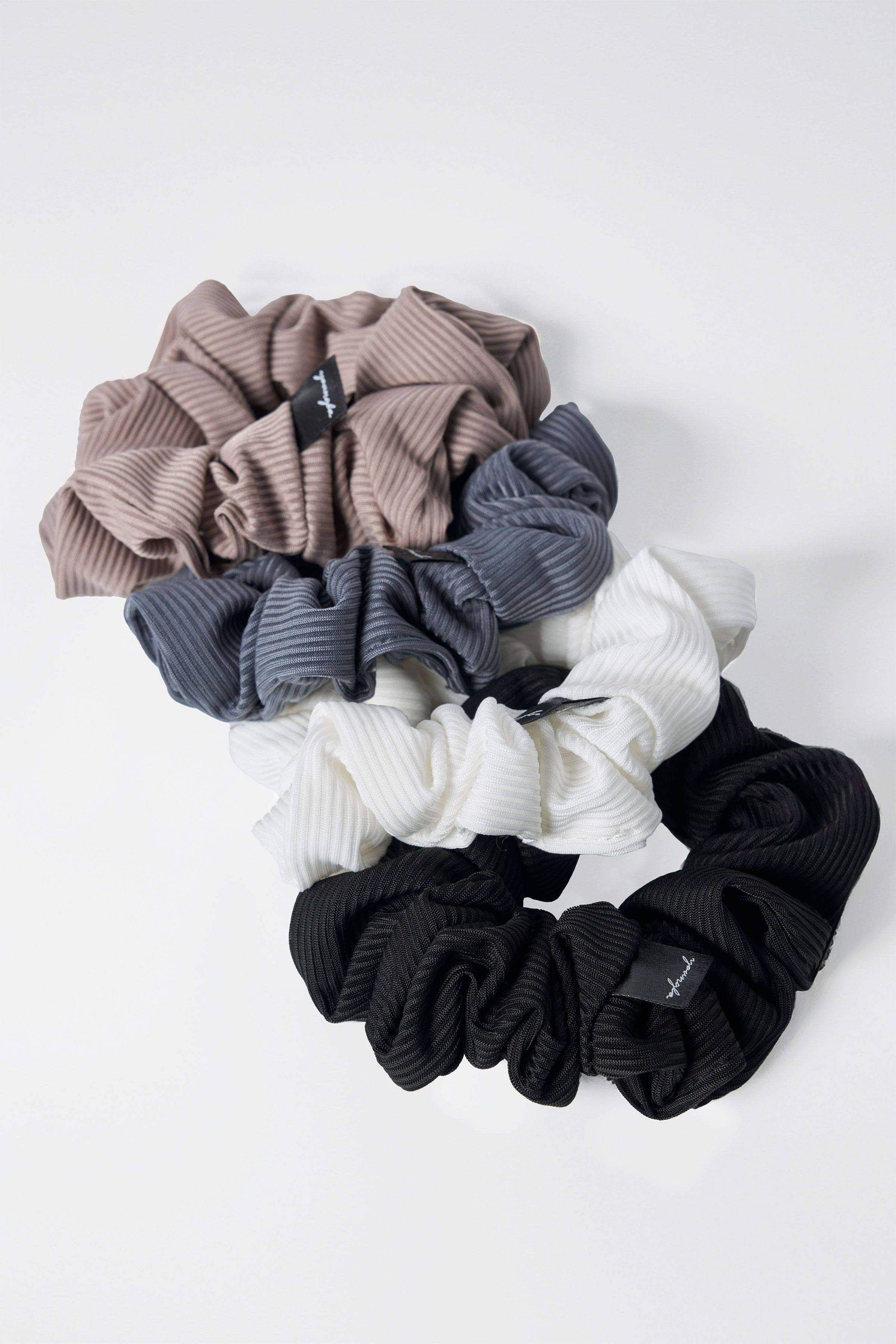 Elegant packaging of luxury silk scrunchies, perfect for gifting.