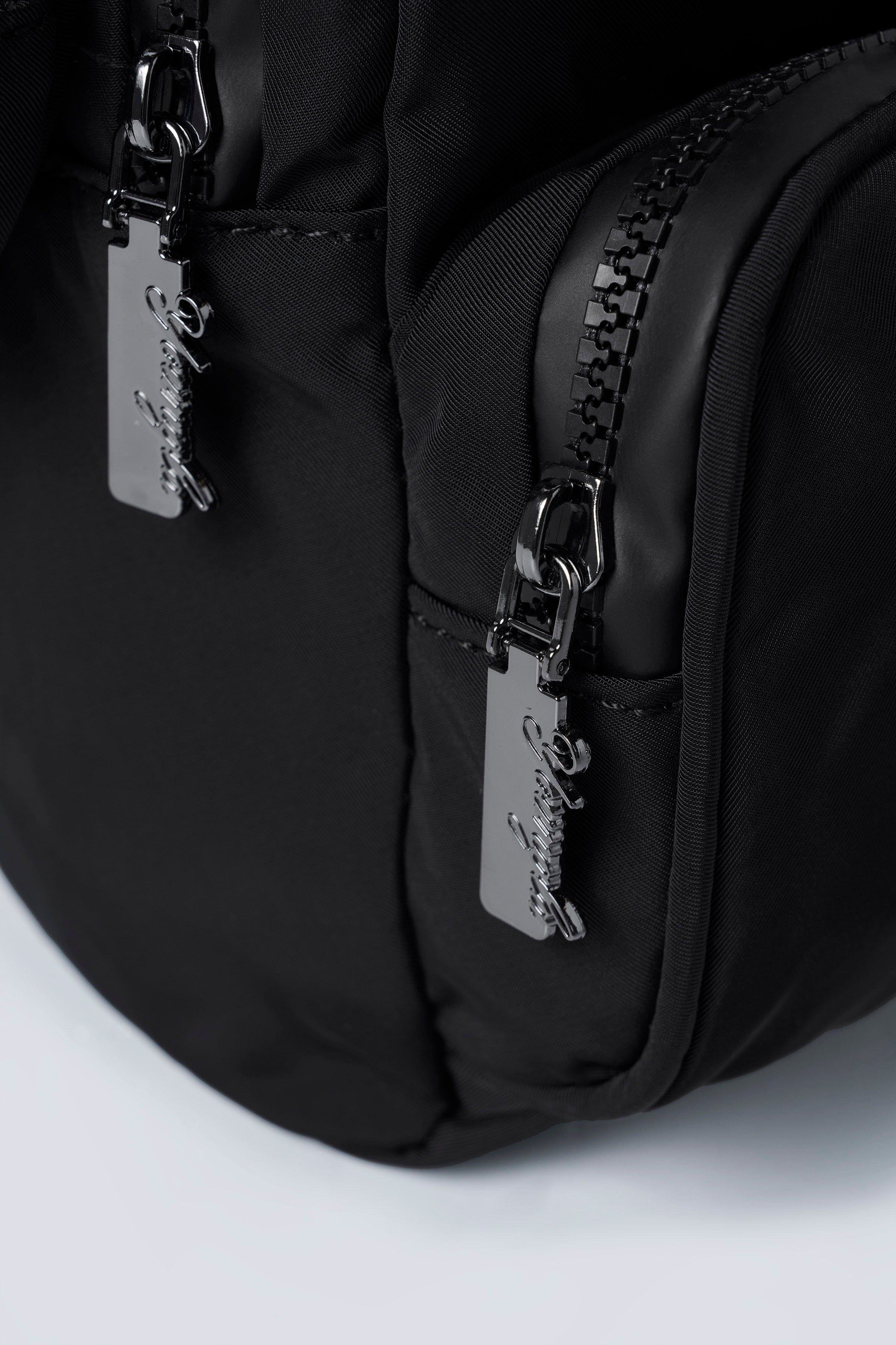 Lightweight backpack hanging on a park bench showing size and build
