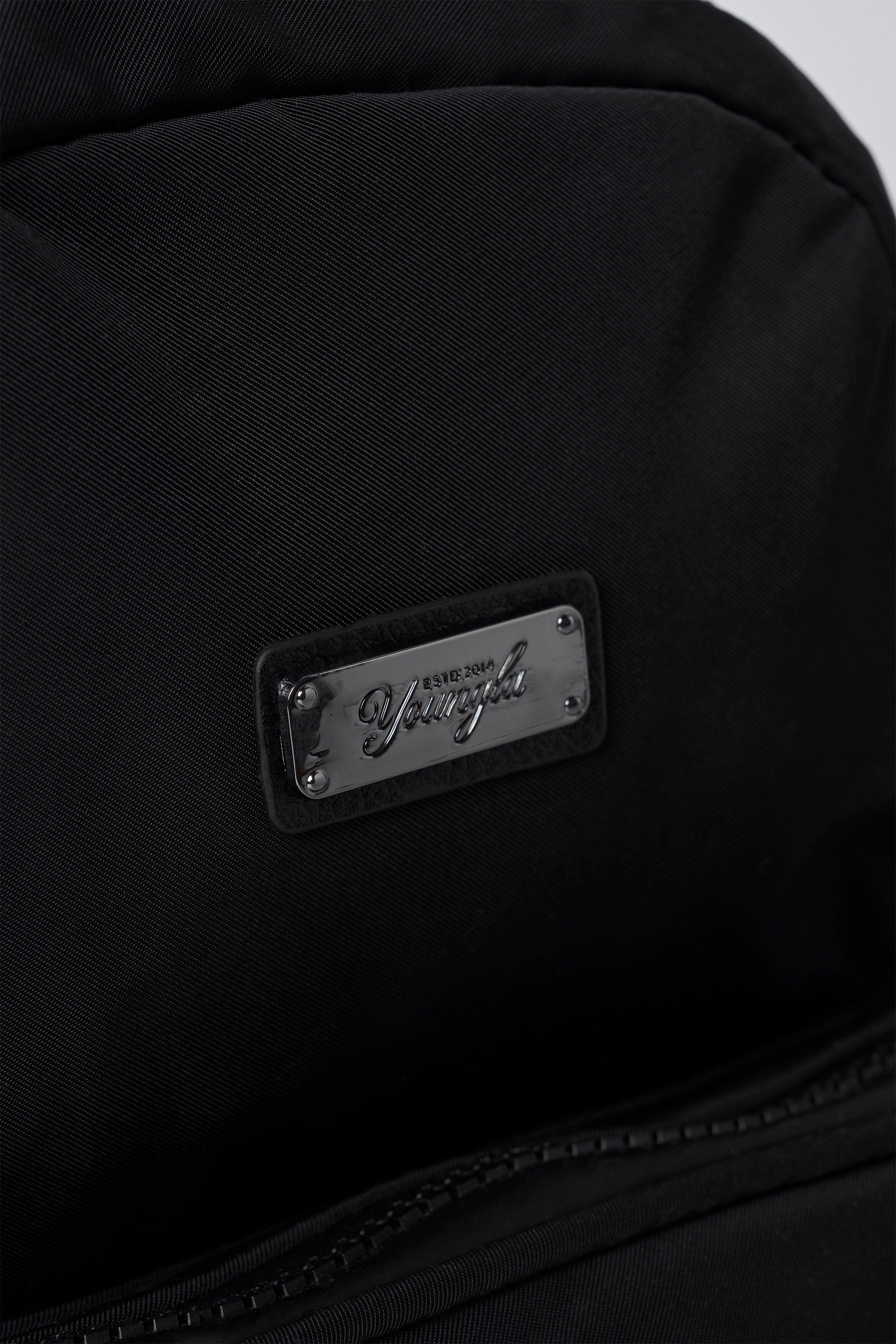 Fun sized backpack with open compartments holding travel essentials