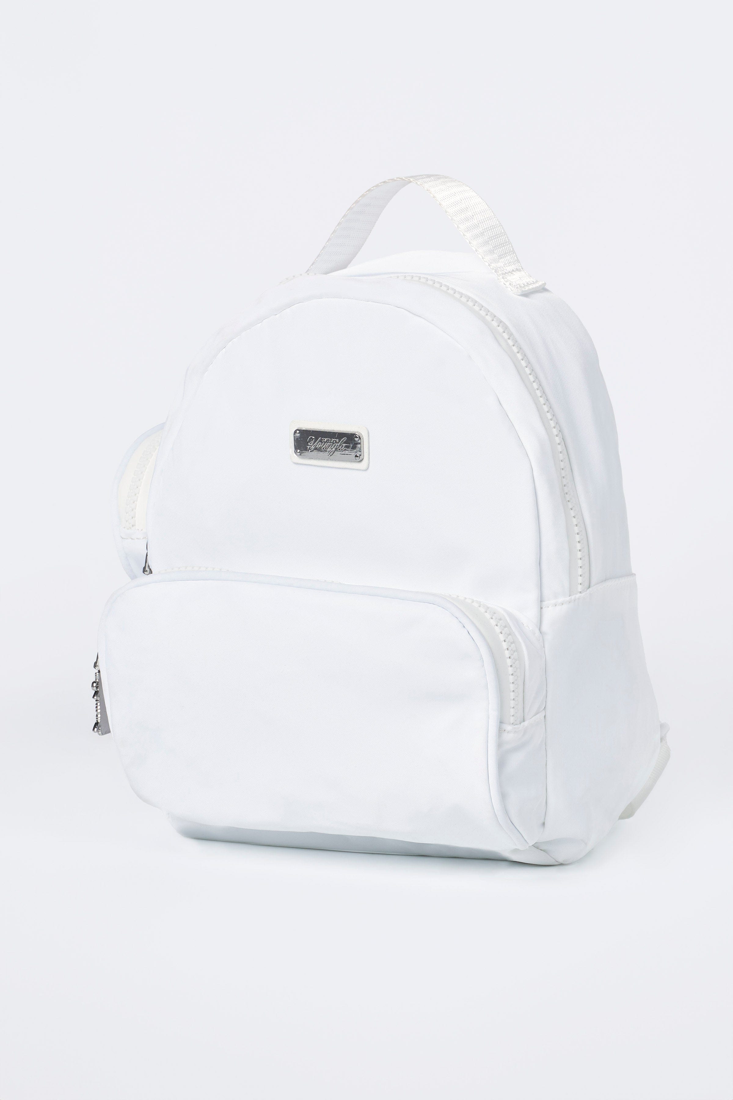 Lightweight backpack hanging on a park bench showing size and build