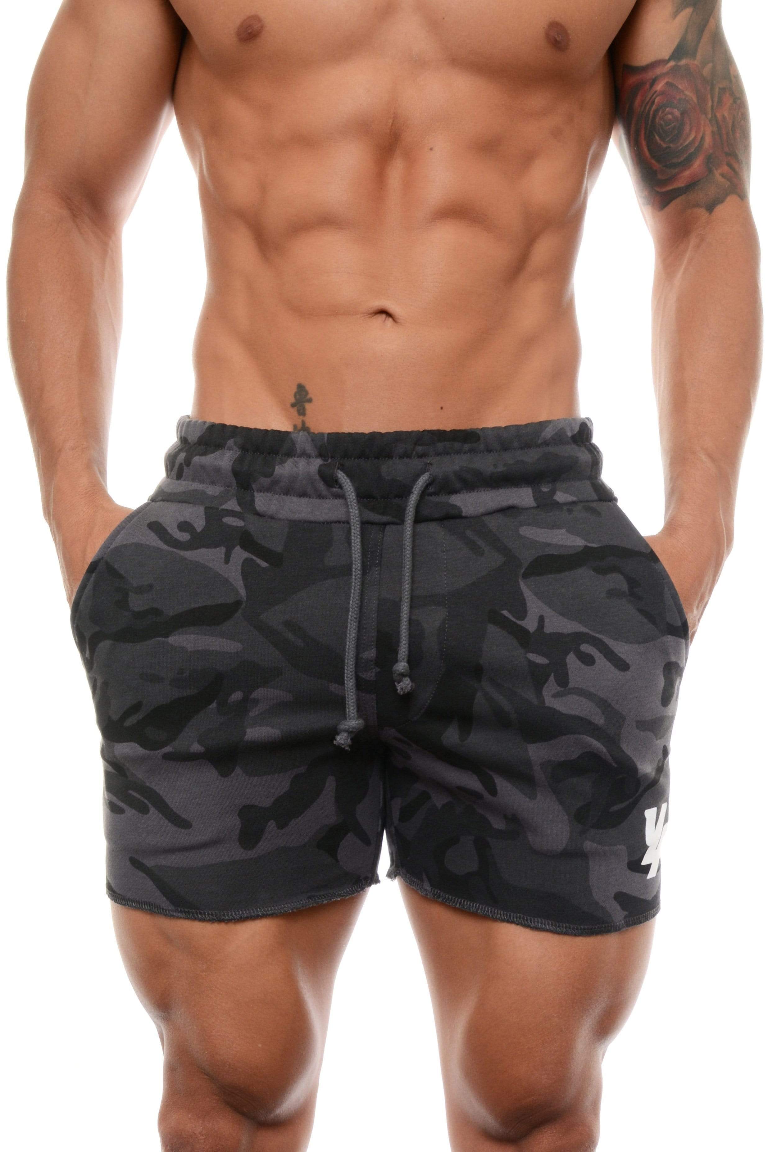 Man wearing gym shorts women style during a workout session with weights