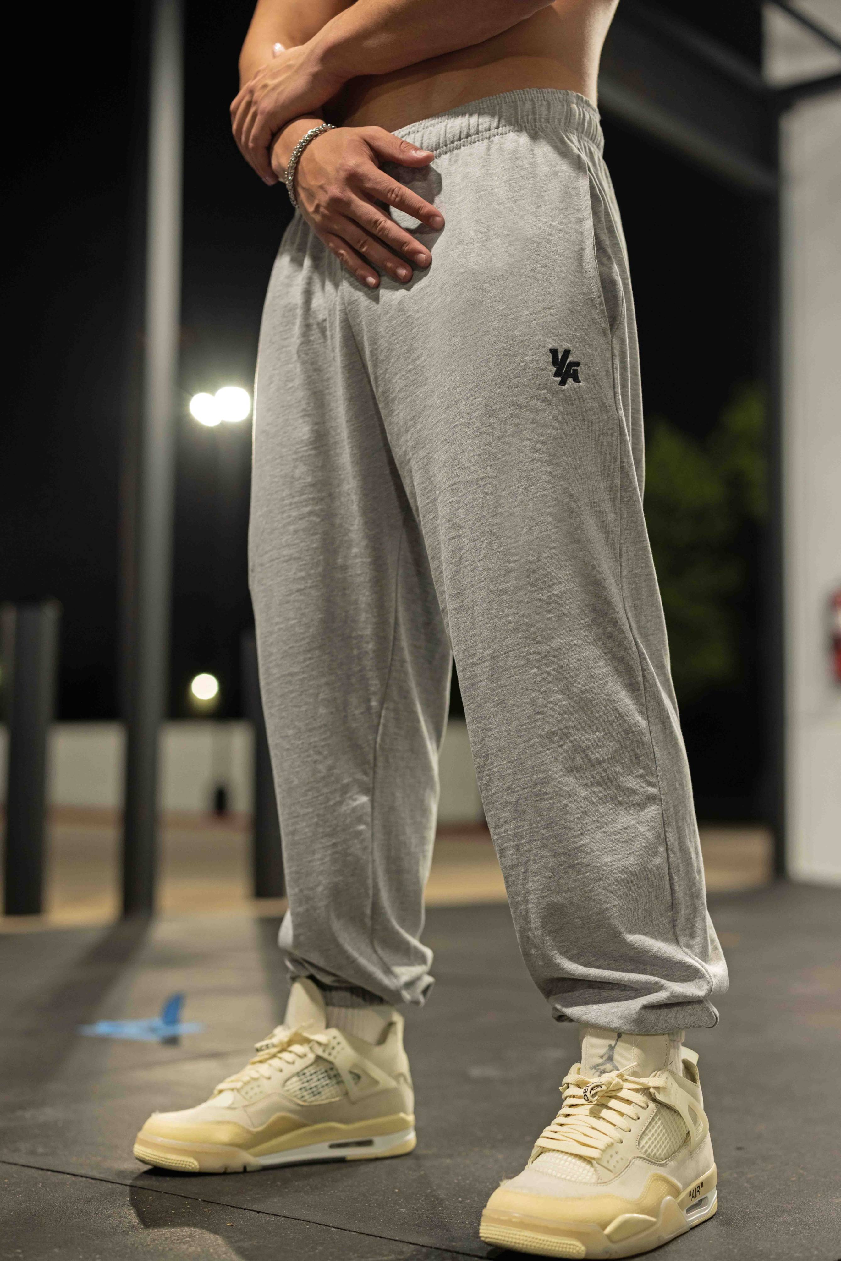Front-angle shot of black joggers styled with casual hoodie for autumn walk
